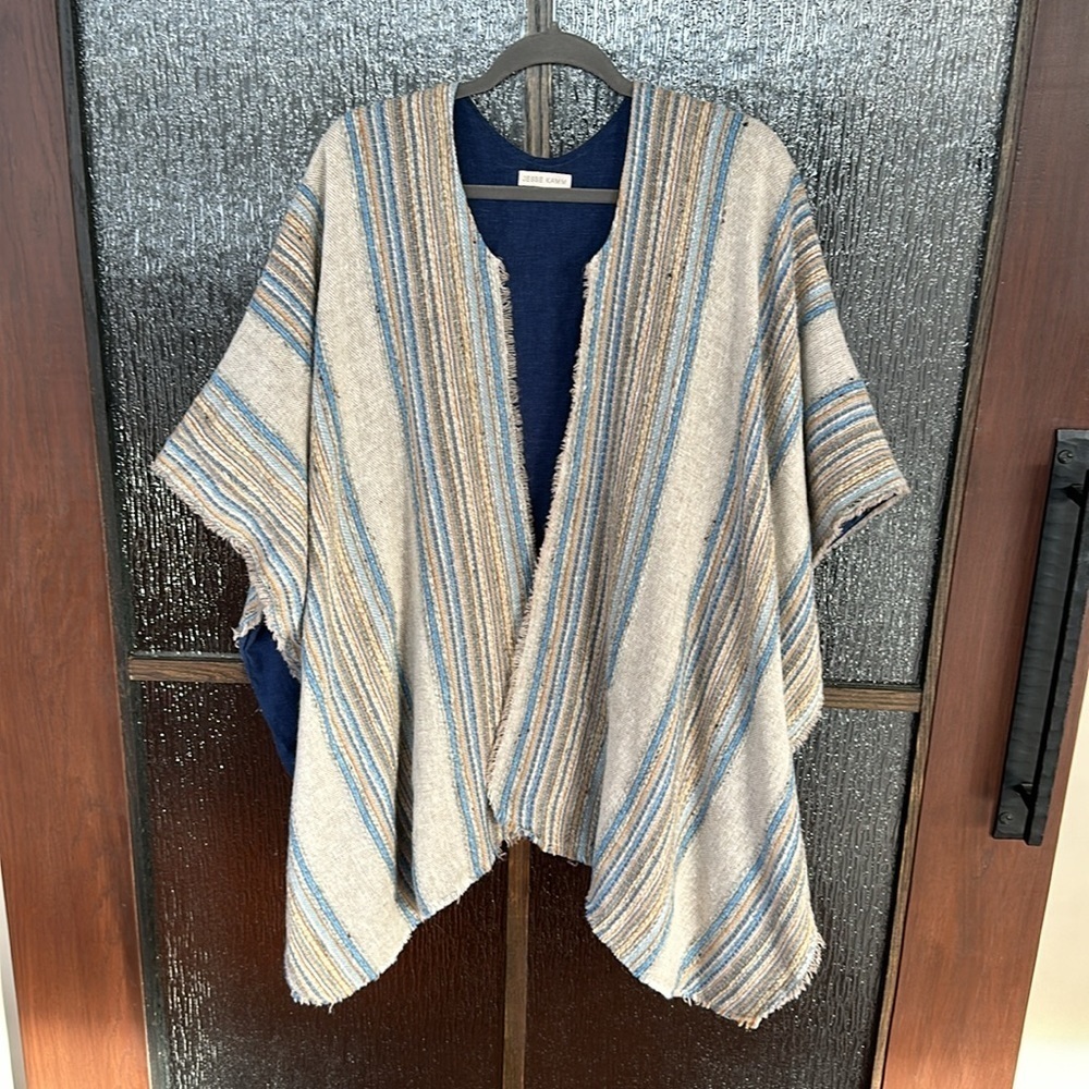 Jesse Kamm warming cape in a blue neutral stripe. One size